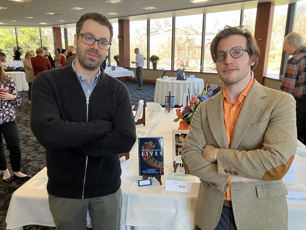 Tyler Yamin and Ben Barson standing with arms crossed, books on display in the background.